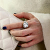 12-carat cushion-cut D color diamond ring with a solitaire halo design, ideal for luxury engagement and timeless elegance.