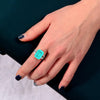 4 carat Paraiba blue three-stone ring in sterling silver and gold with an ocean-inspired design, ideal for engagements.
