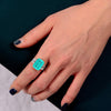 4 carat Paraiba blue three-stone ring in sterling silver and gold with an ocean-inspired design, ideal for engagements.