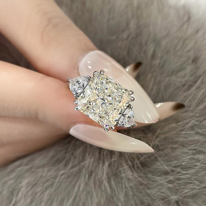 4-carat brilliant princess cut D color diamond ring with three-stone halo design, ideal for weddings and luxury engagements.