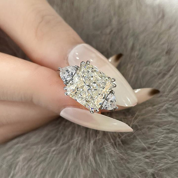 4-carat brilliant princess cut D color diamond ring with three-stone halo design, ideal for weddings and luxury engagements.