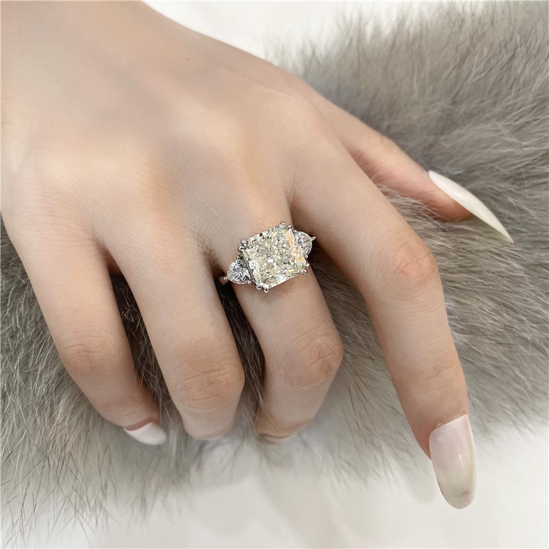 4-carat brilliant princess cut D color diamond ring with three-stone halo design, ideal for weddings and luxury engagements.