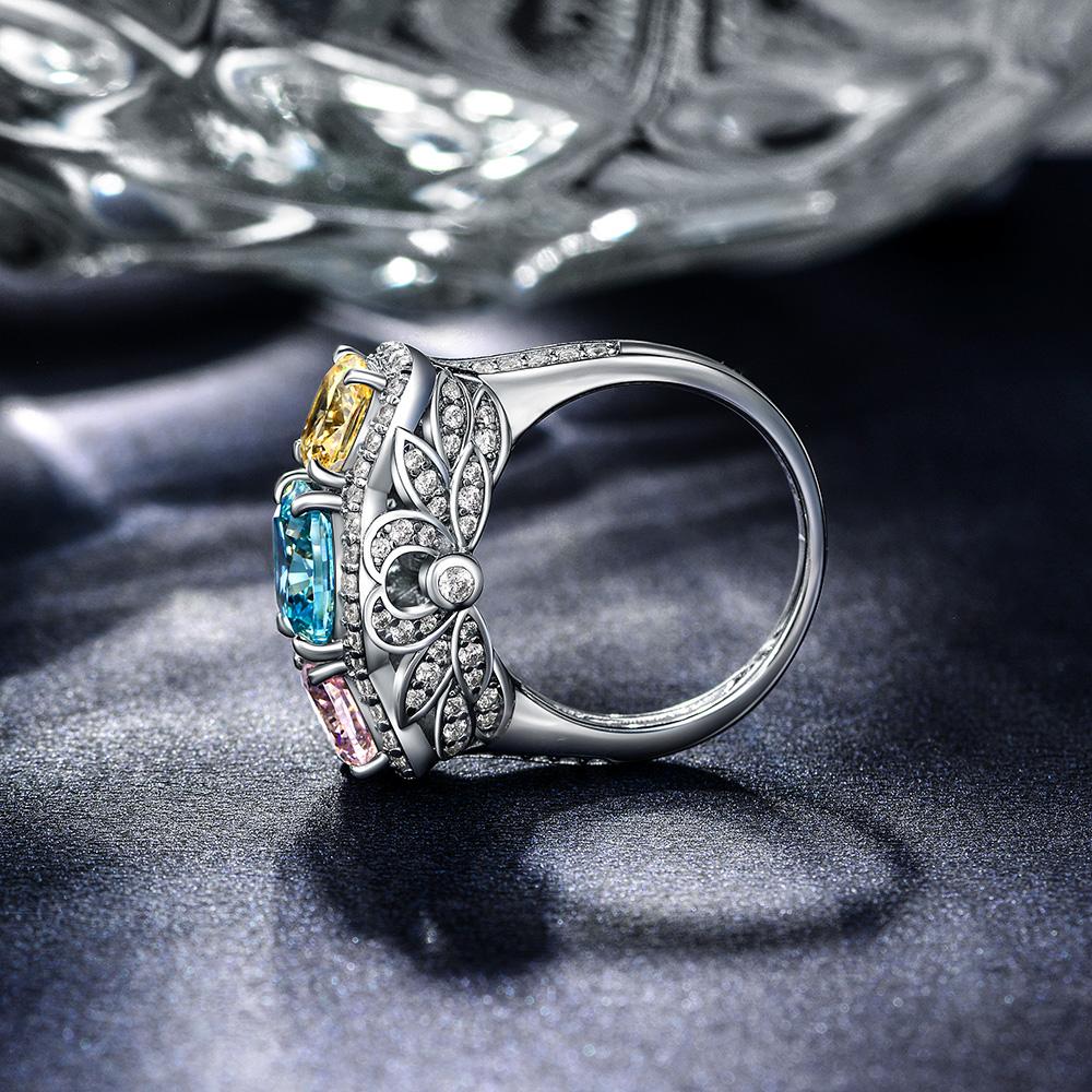 5.0 Carat Cushion-Cut Ocean-Blue Aquamarine Ring with Pink and Yellow Diamonds in a Three Stone Design on White Gold Band