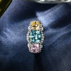 5.0 Carat Cushion-Cut Ocean-Blue Aquamarine Ring with Pink and Yellow Diamonds in a Three Stone Design on White Gold Band