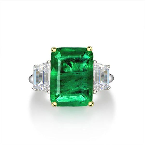 Green Emerald Halo Ring with vivid emerald cut stone, surrounded by a sparkling three stone, perfect for engagements and anniversary
