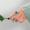 5 carat green emerald halo ring in 925 sterling silver with a vivid green gemstone centerpiece, perfect for engagement and luxury occasions.