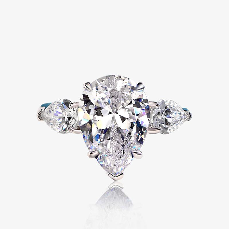 6-carat D color brilliant pear-cut diamond ring with a three-stone design, perfect for weddings and engagements, crafted for ultimate luxury.