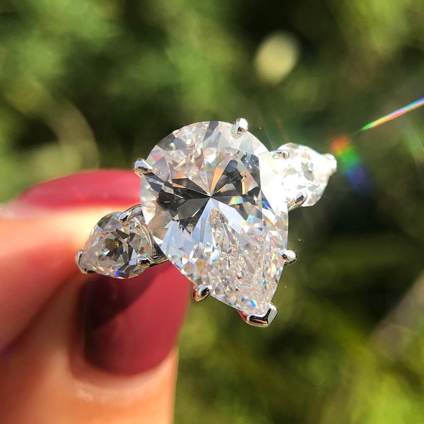 6-carat D color brilliant pear-cut diamond ring with a three-stone design, perfect for weddings and engagements, crafted for ultimate luxury.